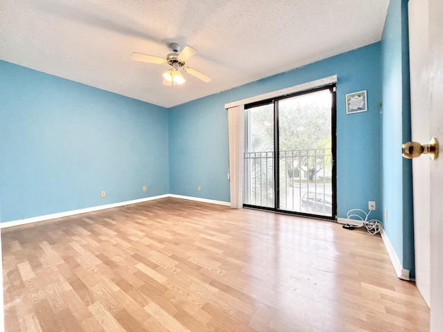 empty room with ceiling fan, a textured ceiling, and light wood-type flooring