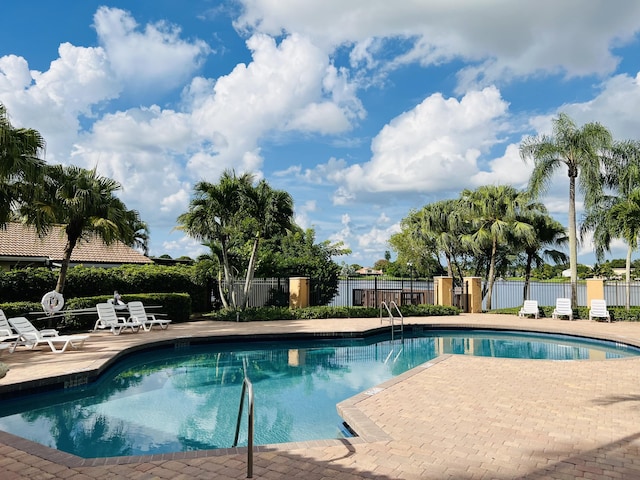 view of swimming pool with a patio area