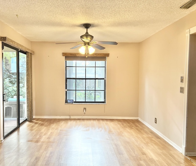 unfurnished room with ceiling fan, a textured ceiling, and light hardwood / wood-style floors