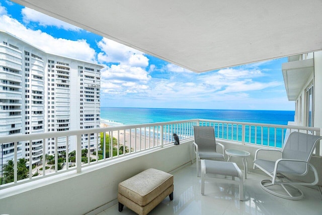 balcony featuring a beach view and a water view