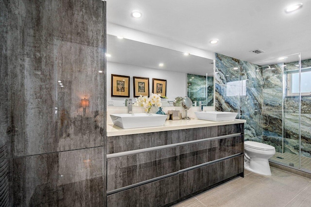 bathroom featuring vanity, toilet, tile patterned floors, and an enclosed shower