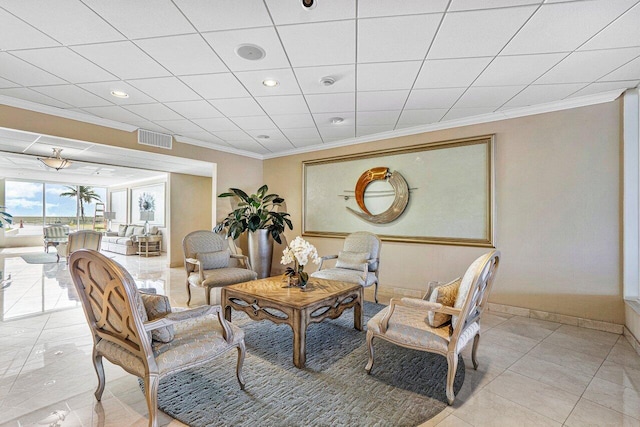 living room with ornamental molding and light tile patterned floors