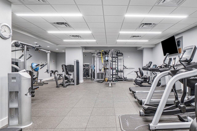 gym with a paneled ceiling