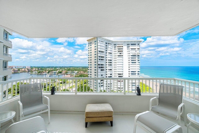 balcony featuring a water view and a view of the beach