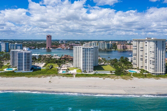 bird's eye view with a water view and a beach view