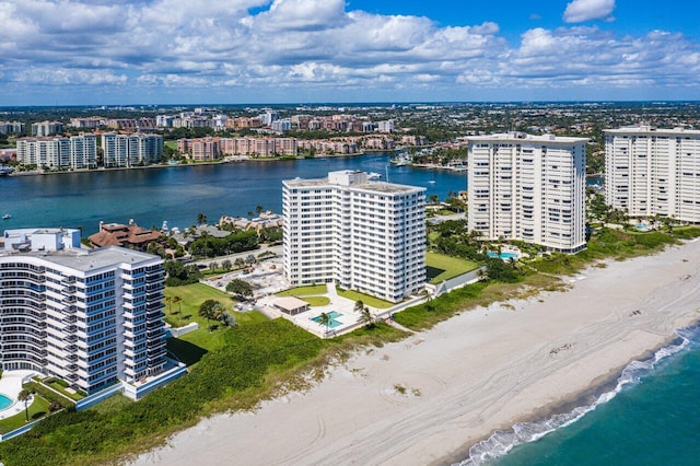 aerial view with a water view and a beach view