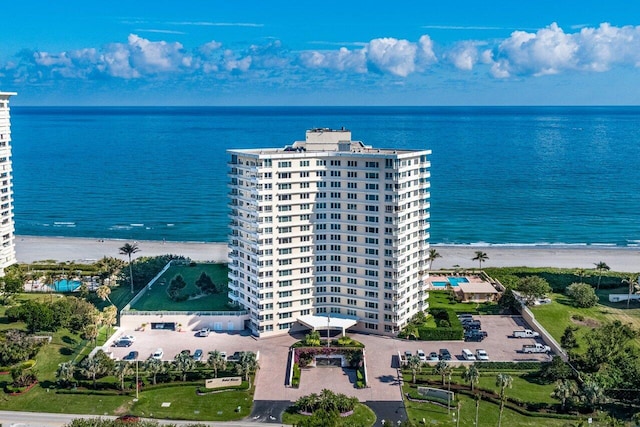 drone / aerial view with a water view and a beach view