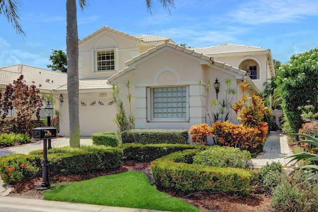 mediterranean / spanish home featuring a garage