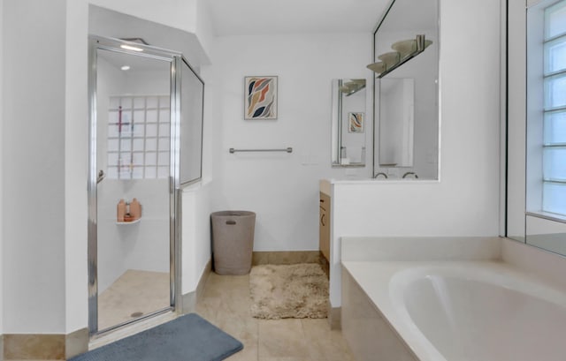 bathroom featuring tile patterned flooring, shower with separate bathtub, and vanity