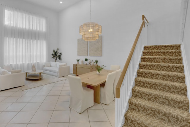 tiled dining room featuring a chandelier and a healthy amount of sunlight