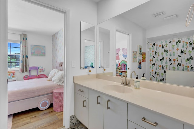 bathroom with vanity and hardwood / wood-style flooring