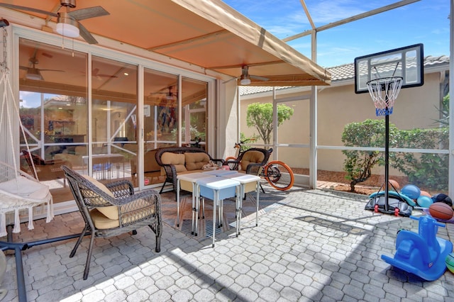 view of patio / terrace with glass enclosure, outdoor lounge area, and ceiling fan