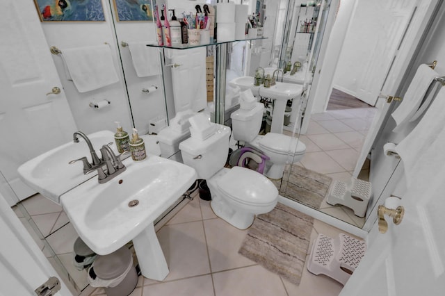 bathroom with toilet and tile patterned floors