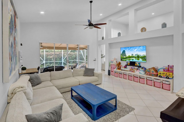 living room with high vaulted ceiling, ceiling fan, and light tile patterned floors