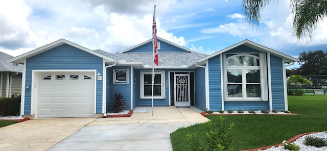 single story home with a garage and a front lawn