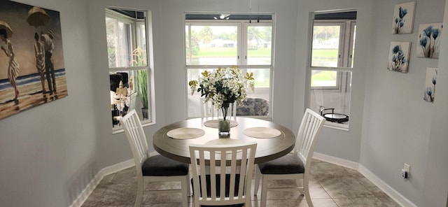 dining area featuring light tile patterned flooring