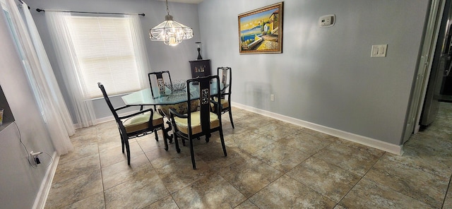 dining space featuring a healthy amount of sunlight and an inviting chandelier