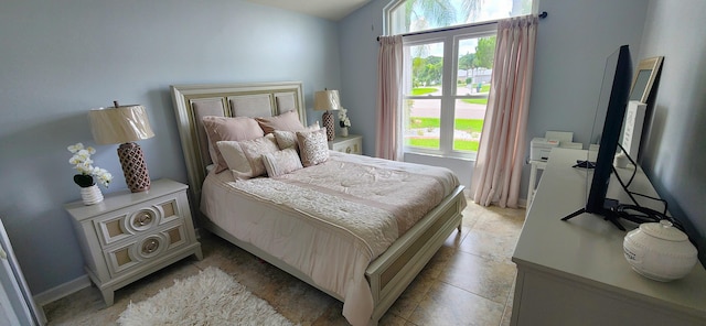 tiled bedroom with multiple windows