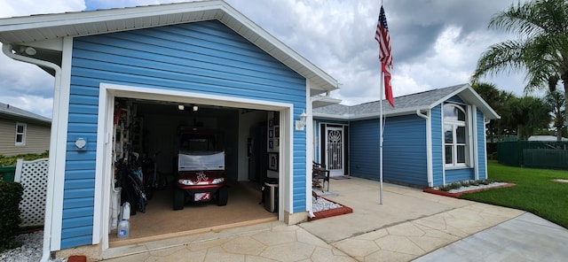 garage featuring a yard and wood walls