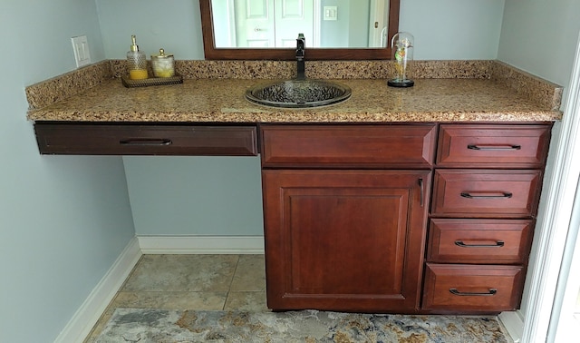 kitchen with light stone countertops and sink