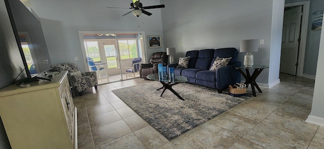 living room with ceiling fan and a towering ceiling