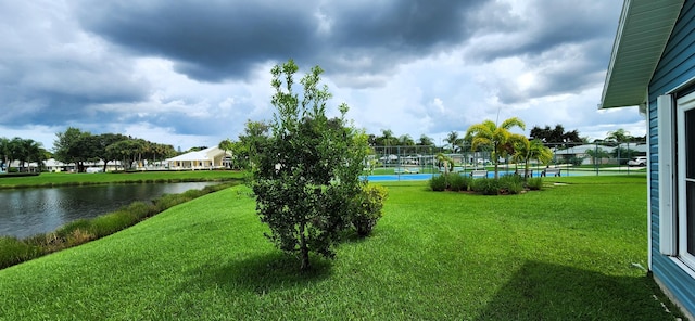 exterior space featuring a water view and a yard