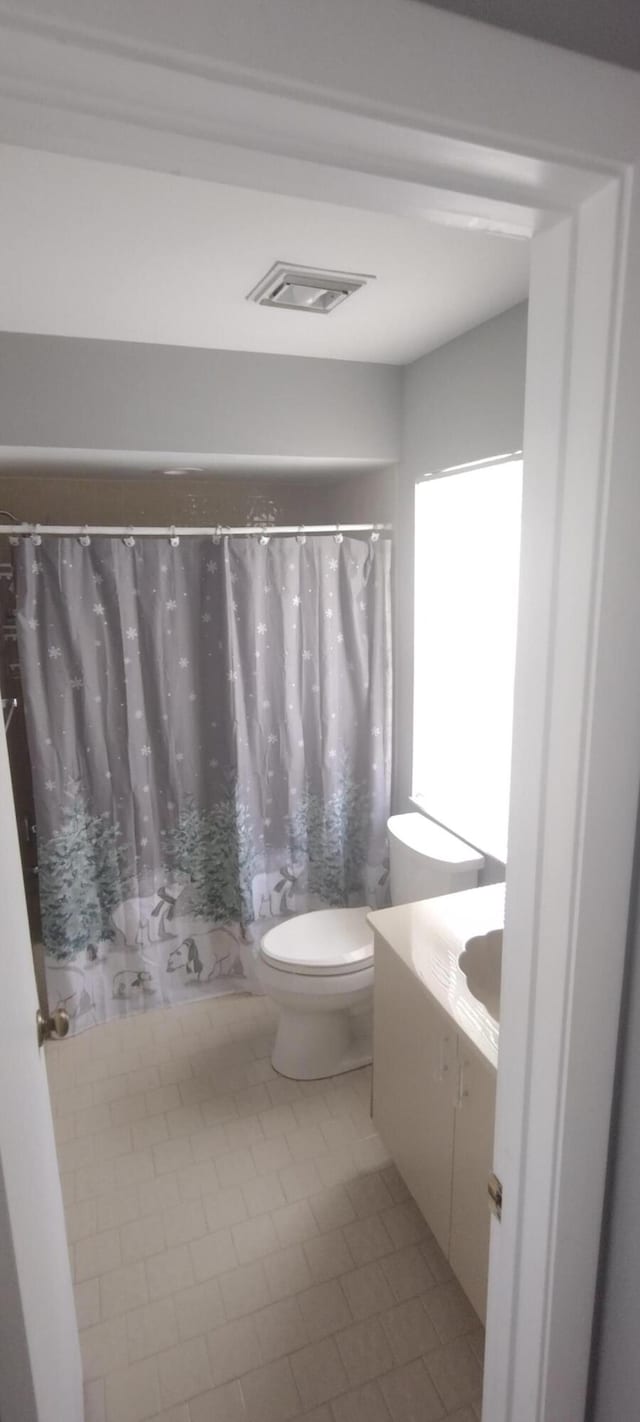 bathroom featuring vanity, toilet, and tile patterned floors