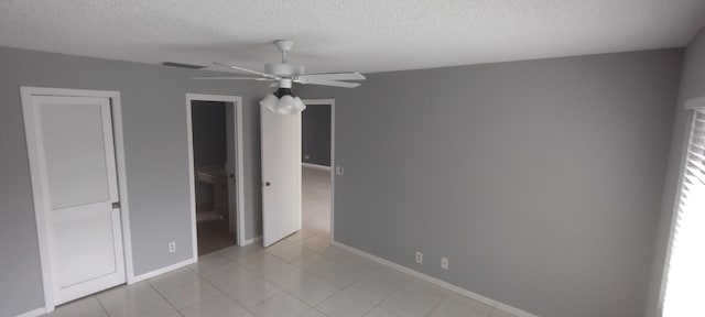 unfurnished bedroom featuring a textured ceiling and ceiling fan