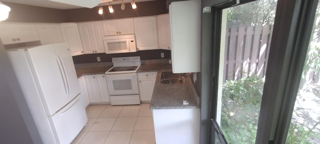 kitchen with white cabinets, white appliances, sink, and a healthy amount of sunlight