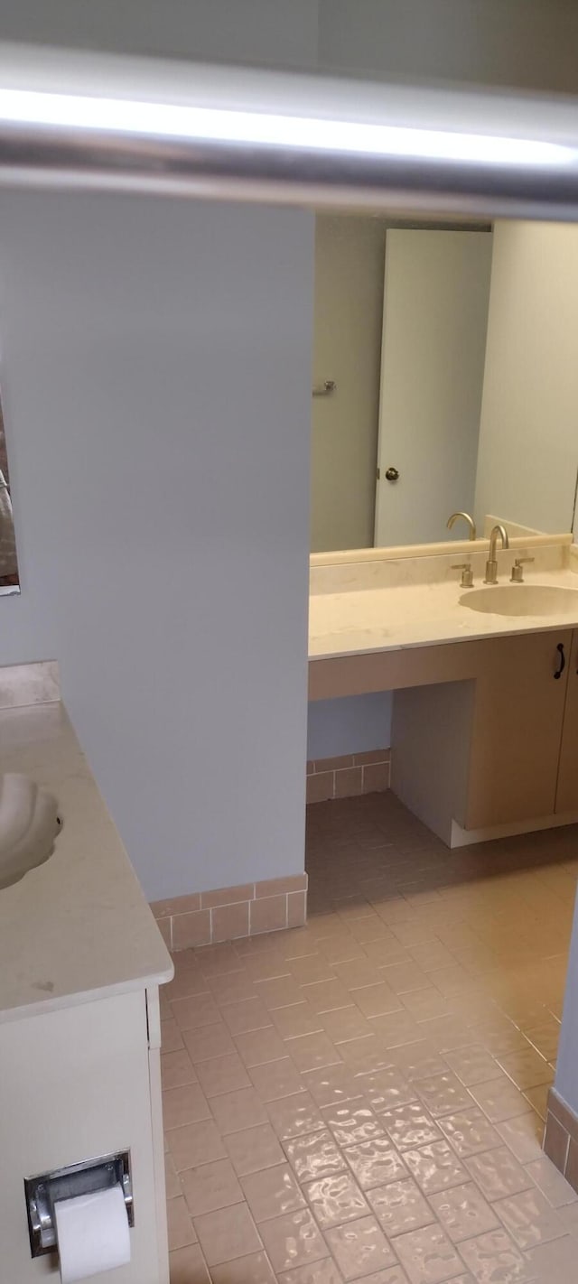 bathroom with tile patterned flooring and vanity