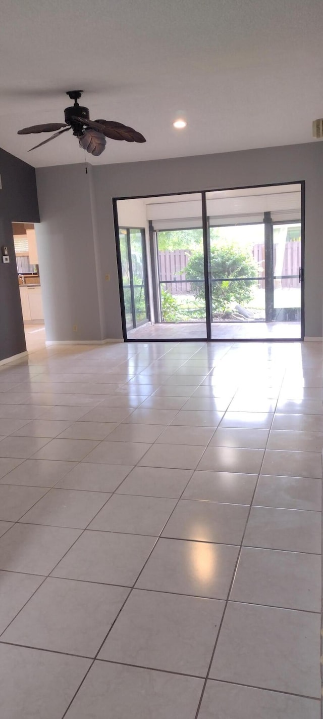 spare room with ceiling fan and light tile patterned floors