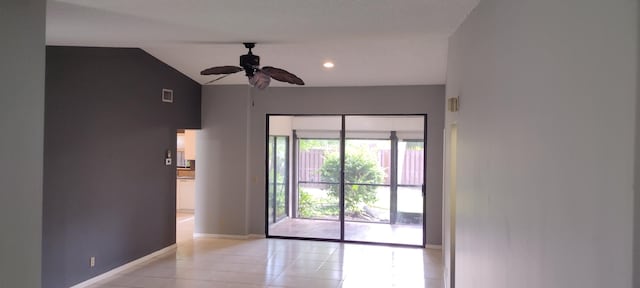 tiled empty room with ceiling fan and vaulted ceiling