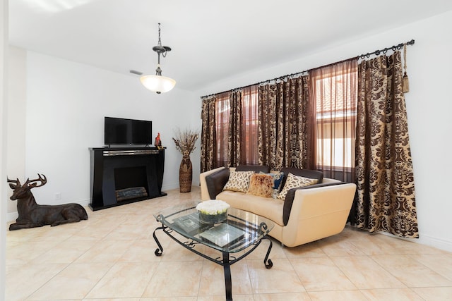 tiled living area with visible vents and baseboards