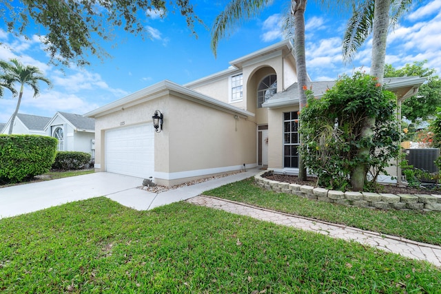 view of front of property featuring concrete driveway, a garage, a front lawn, and stucco siding