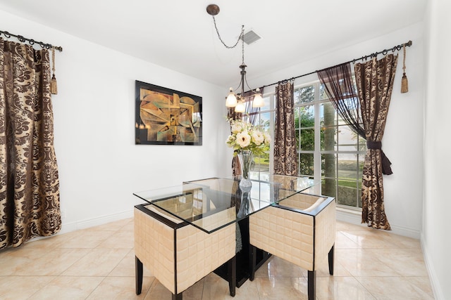 dining area featuring light tile patterned floors, baseboards, and an inviting chandelier