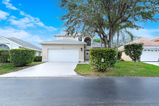 view of front of property featuring stucco siding, driveway, a front lawn, and a garage