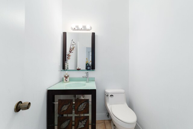 bathroom with vanity, tile patterned floors, toilet, and baseboards