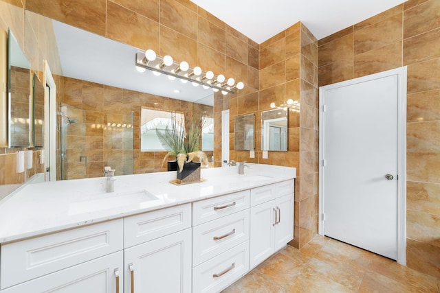 full bath featuring a sink, tile walls, and a shower stall