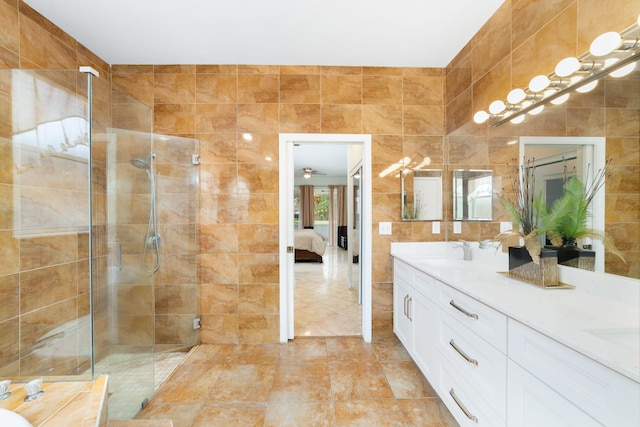 ensuite bathroom featuring a sink, tile walls, ensuite bath, and a shower stall