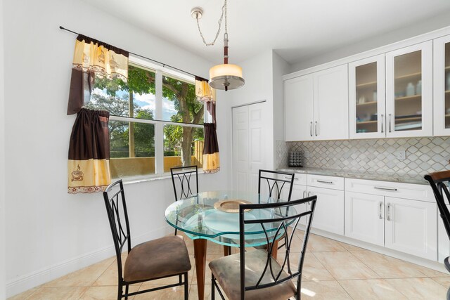 dining room featuring light tile patterned floors and baseboards