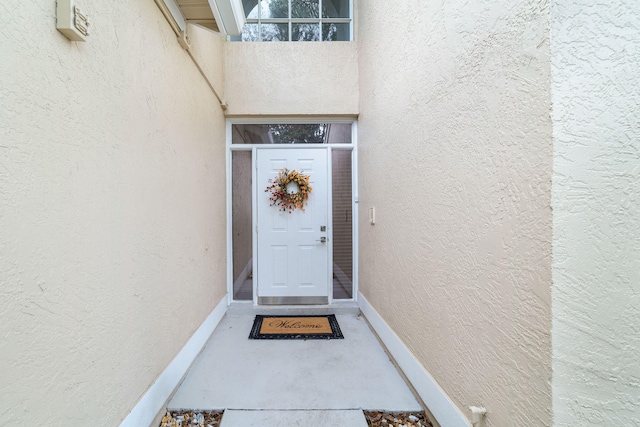 doorway to property with stucco siding