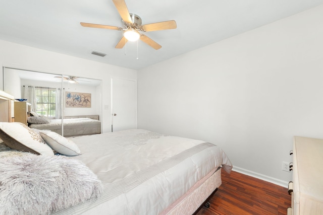 bedroom with visible vents, ceiling fan, baseboards, and wood finished floors