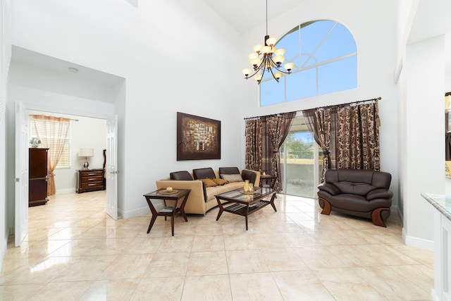 interior space with a notable chandelier, plenty of natural light, baseboards, and a towering ceiling