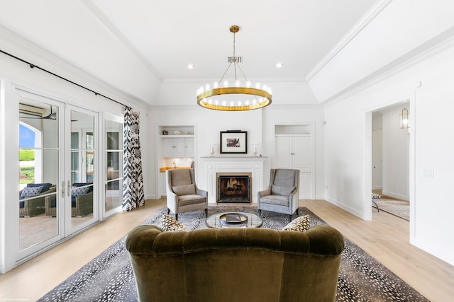 living room featuring french doors, crown molding, light hardwood / wood-style flooring, and a chandelier