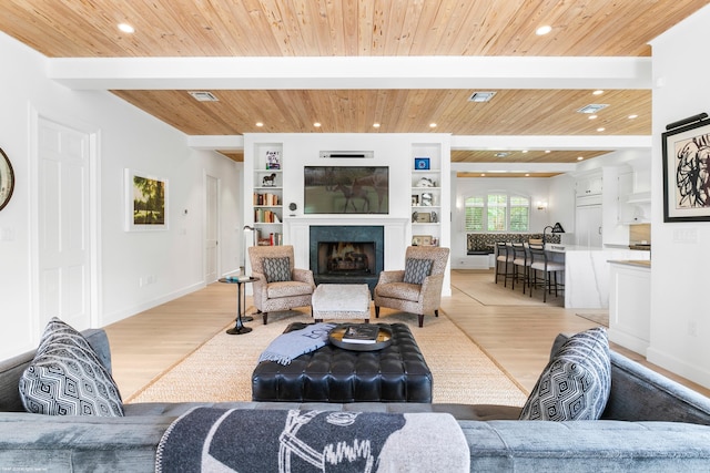 living room featuring light hardwood / wood-style flooring, wooden ceiling, and built in shelves