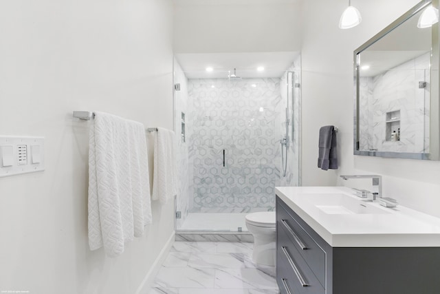 bathroom featuring vanity, toilet, and a shower with shower door