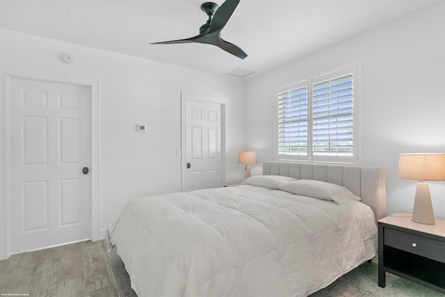 bedroom with light hardwood / wood-style floors and ceiling fan