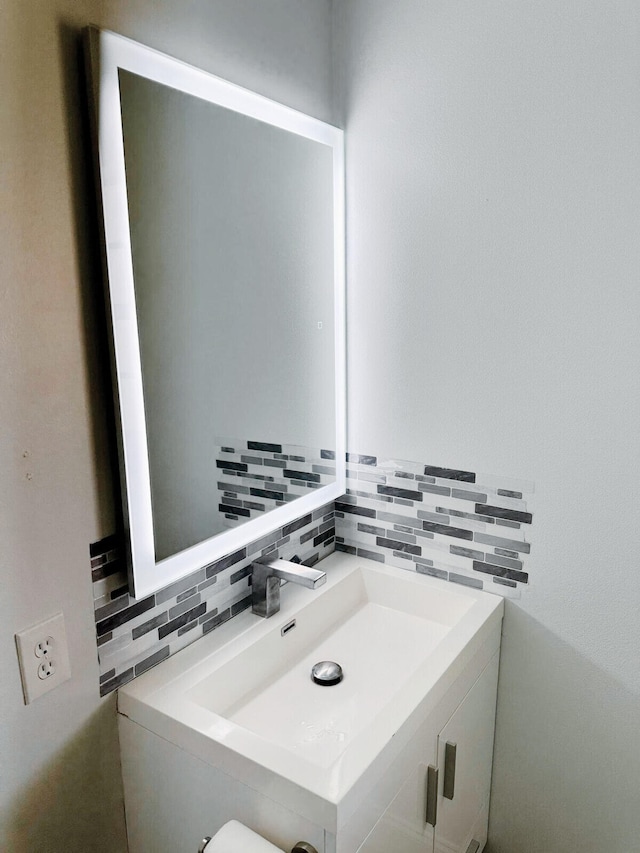 bathroom featuring decorative backsplash and sink