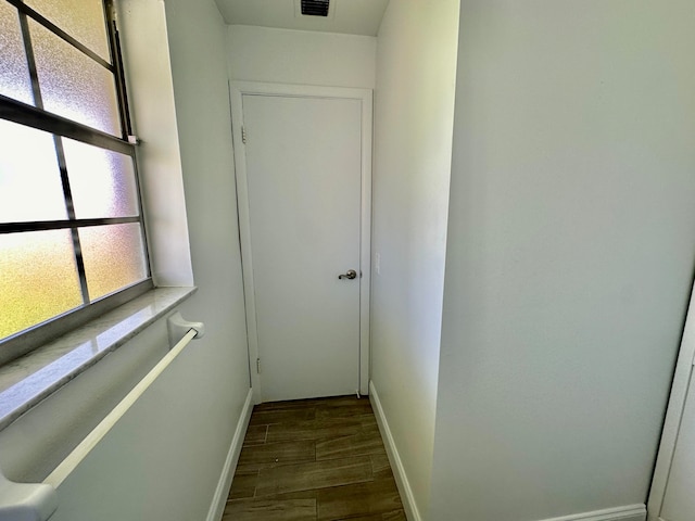 corridor with dark hardwood / wood-style floors