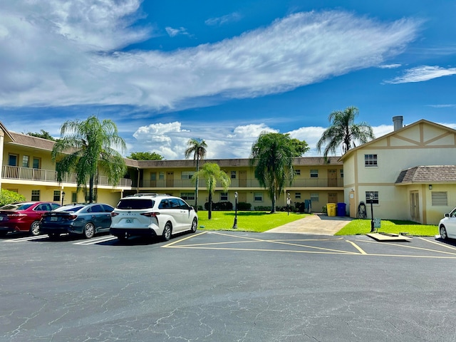 view of vehicle parking with a yard